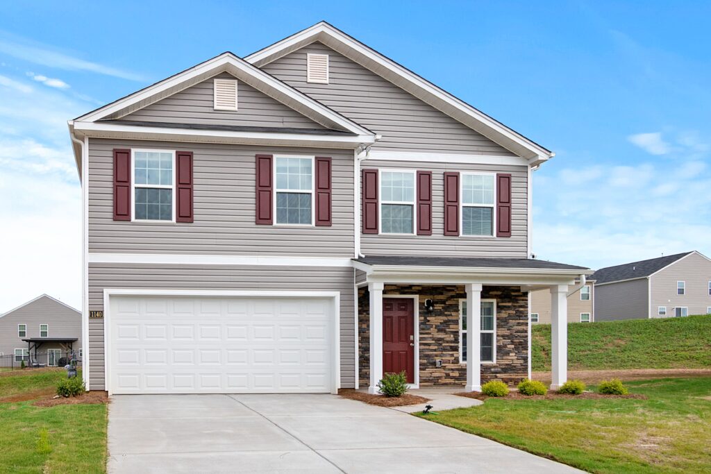 pexels-photo-4832509-4832509 Spacious two-story suburban house with garage and landscaped front yard.